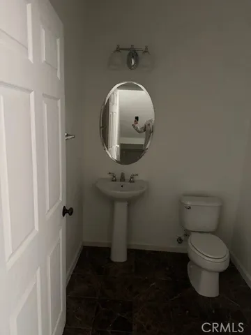 a bathroom with a toilet and a mirror