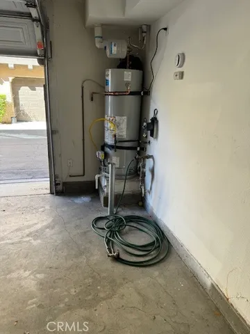 a room with water heater and stainless steel appliances