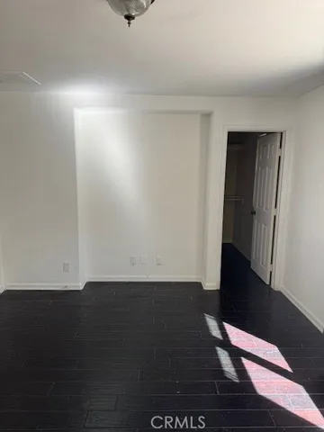 an empty room with wooden floor