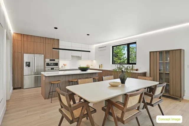 a kitchen with stainless steel appliances kitchen island granite countertop a dining table chairs and granite counter tops