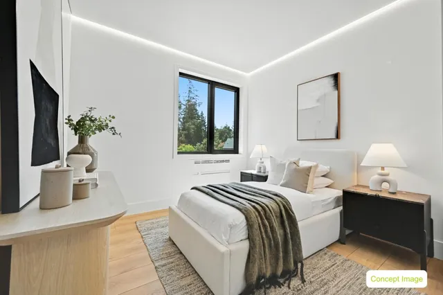 a bedroom with bed and a potted plant