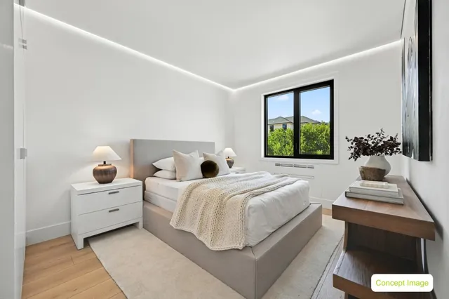 a bedroom with a bed and a large window