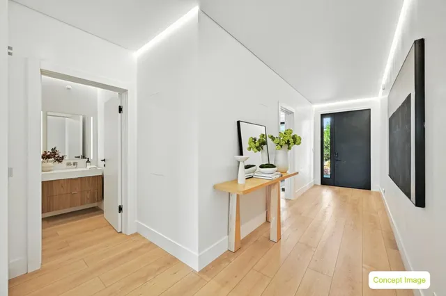 a view of a hallway to dining room with furniture and wooden floor