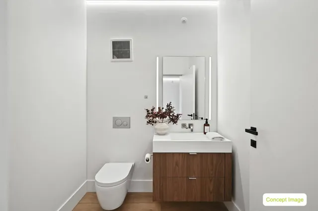 a bathroom with a sink toilet and mirror