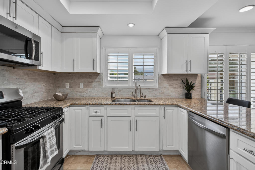 9325 La Shell Drive Tujunga, CA 91042 - Photo 13 of 46 a kitchen with stainless steel appliances granite countertop a sink stove top oven and cabinets