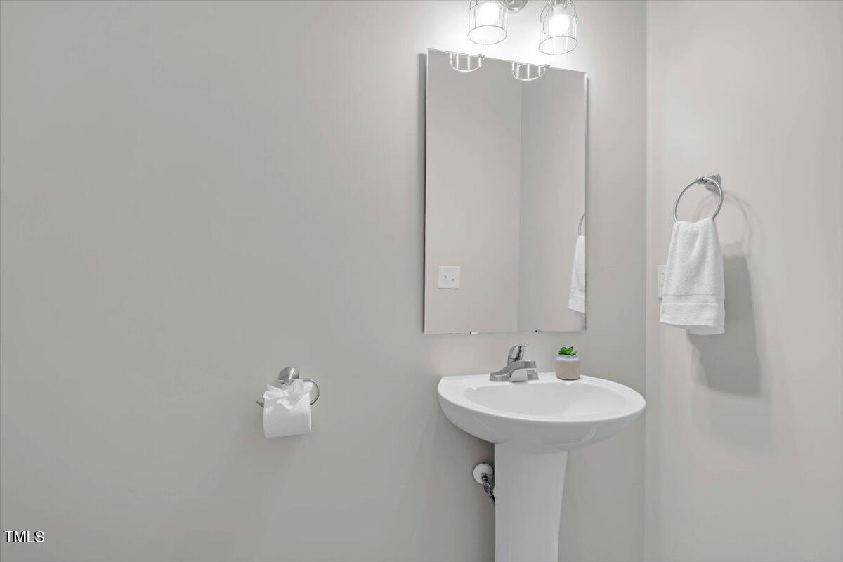 9834 Bitter Melon Drive Angier, NC 27501 - Photo 11 of 29 a bathroom with a sink and mirror