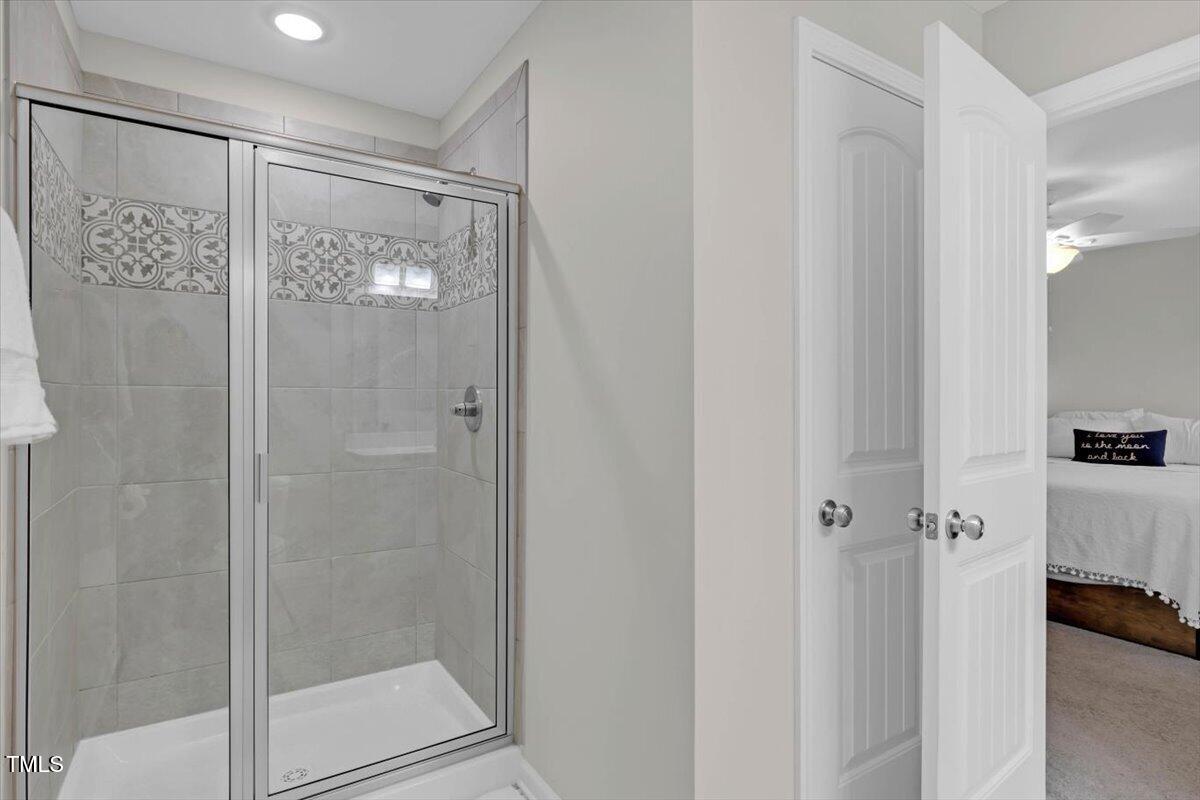 9834 Bitter Melon Drive Angier, NC 27501 - Photo 17 of 29 a bathroom with a glass shower door