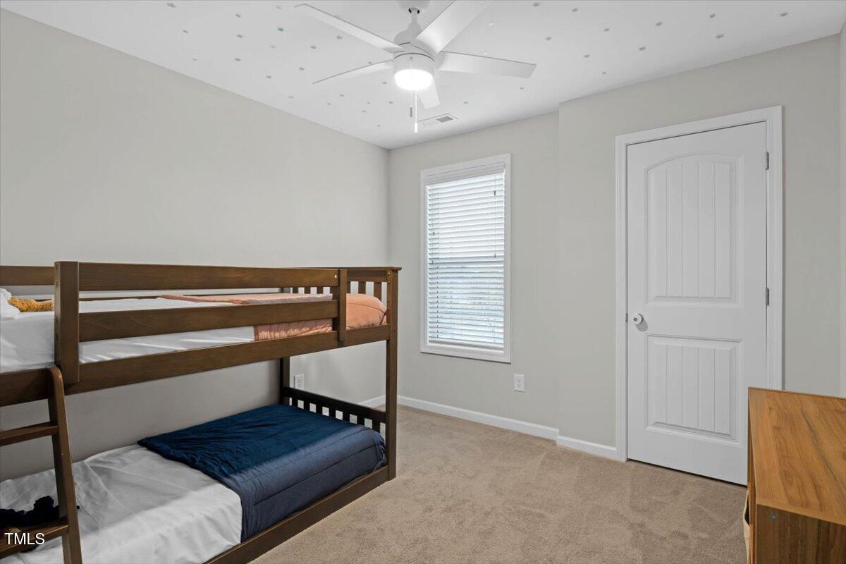 9834 Bitter Melon Drive Angier, NC 27501 - Photo 20 of 29 a bedroom with furniture and a window