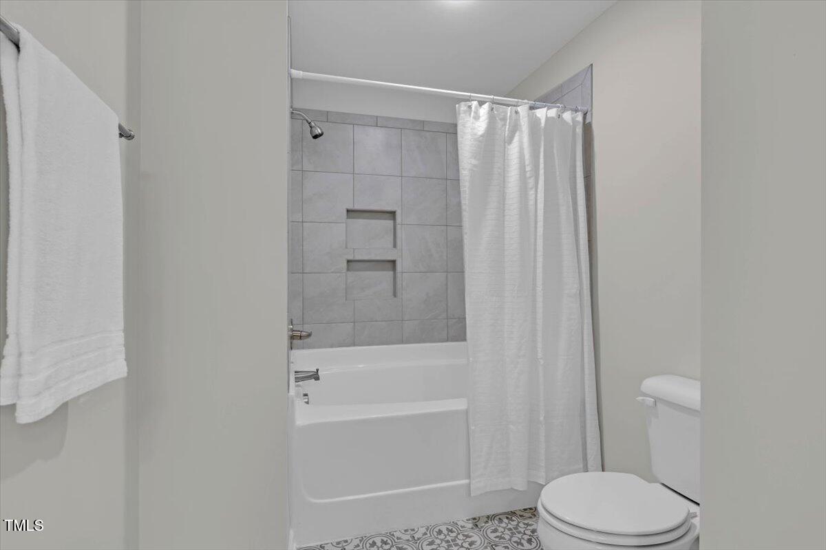 9834 Bitter Melon Drive Angier, NC 27501 - Photo 23 of 29 a bathroom with a toilet and a bathtub