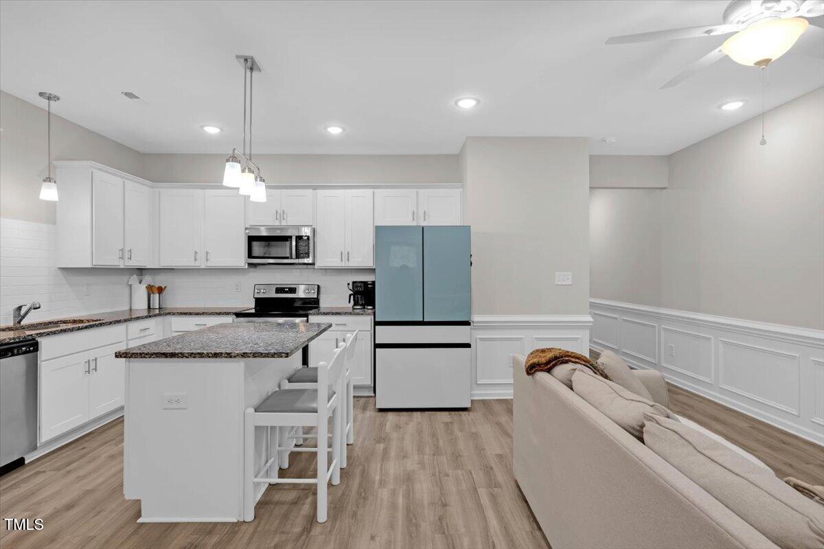 9834 Bitter Melon Drive Angier, NC 27501 - Photo 3 of 29 a kitchen with a refrigerator a sink and white cabinets