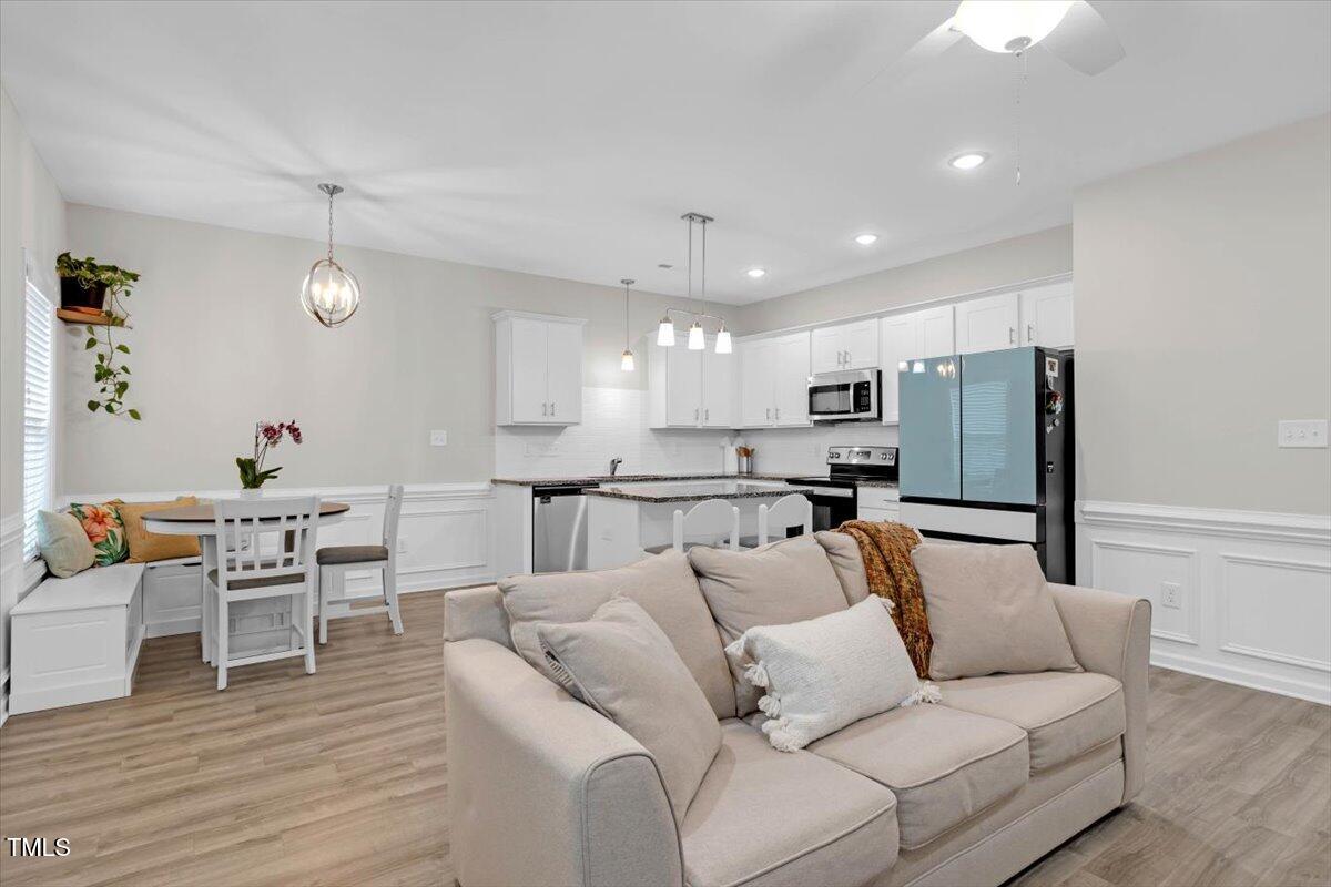 9834 Bitter Melon Drive Angier, NC 27501 - Photo 5 of 29 a living room with furniture and kitchen view