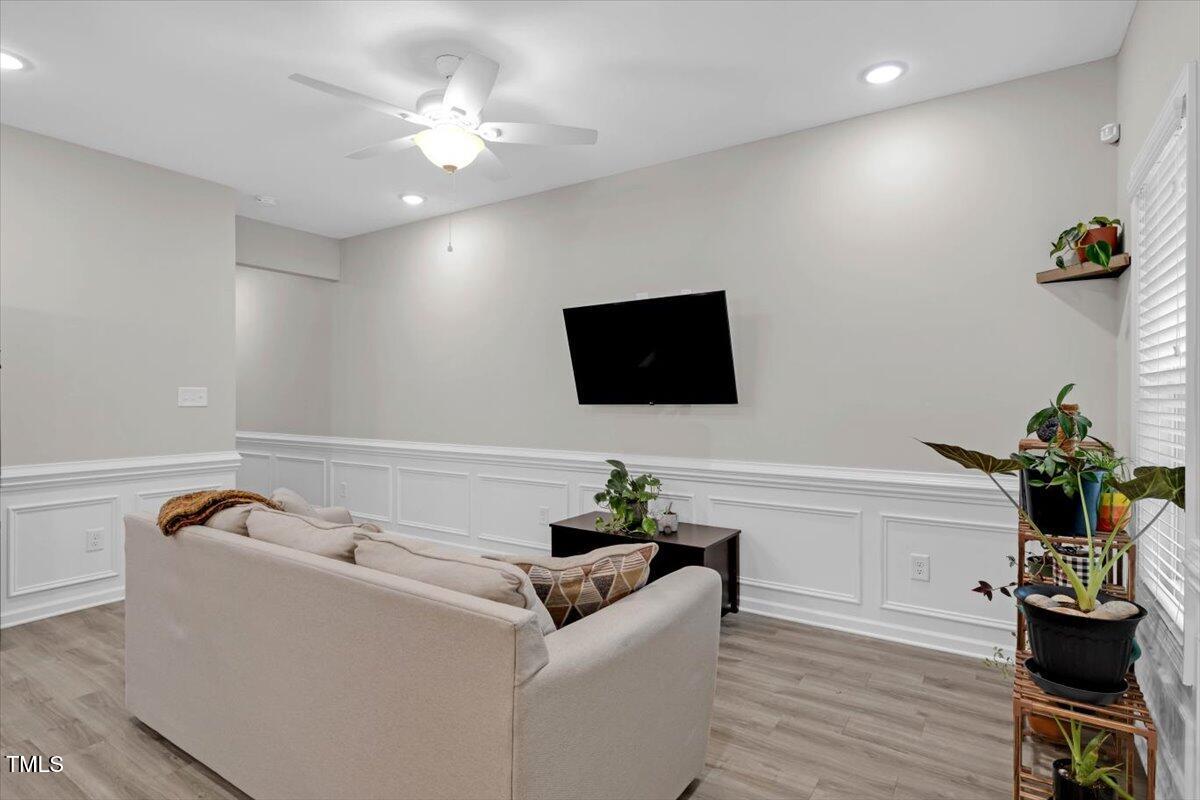 9834 Bitter Melon Drive Angier, NC 27501 - Photo 6 of 29 a living room with furniture and a flat screen tv
