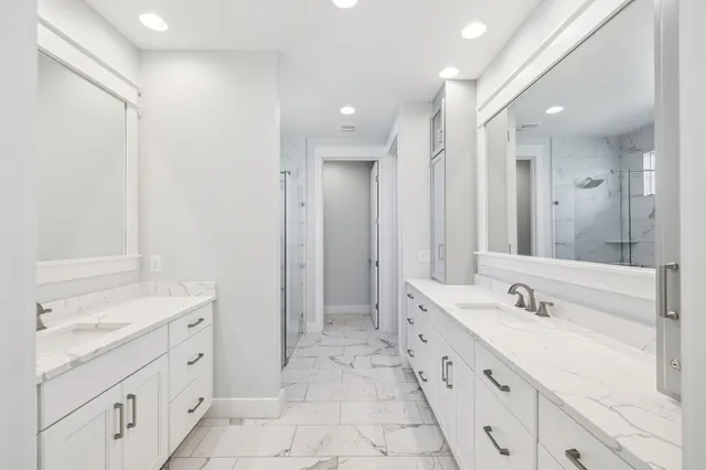 a spacious bathroom with a shower sink double and mirror
