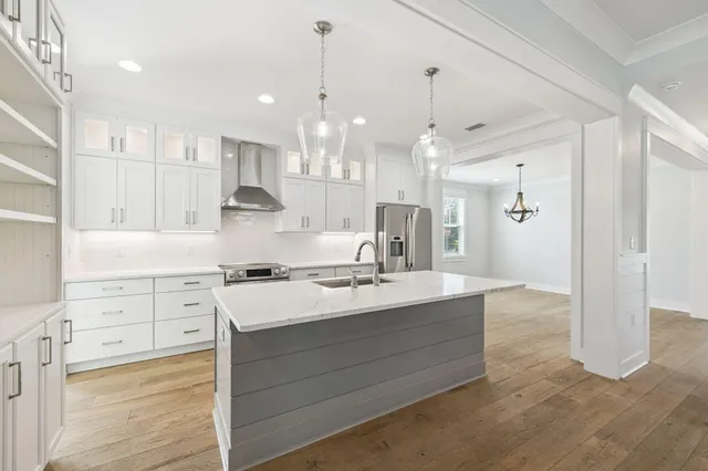 a kitchen with a refrigerator sink and cabinets