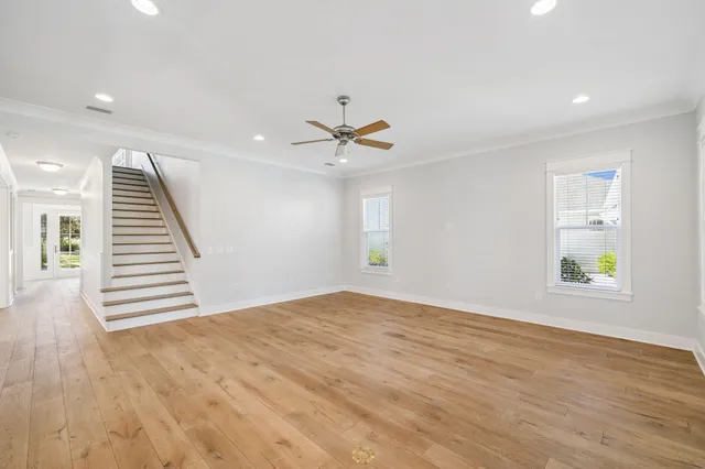 a view of a kitchen with wooden floor and windows
