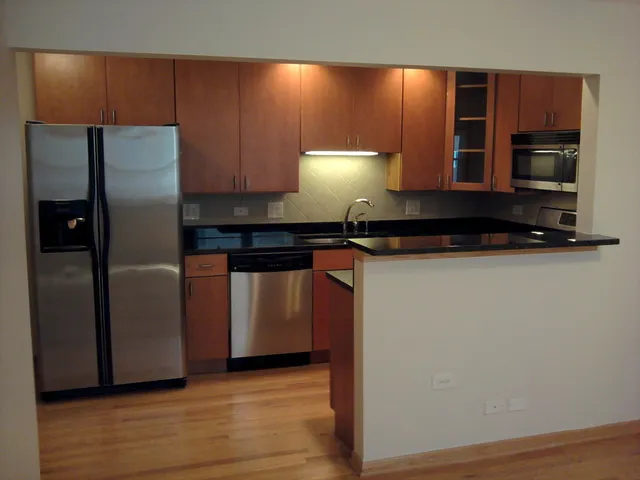 a kitchen with stainless steel appliances a refrigerator and a stove