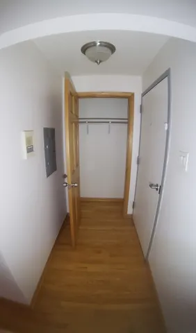 a view of hallway with wooden floor