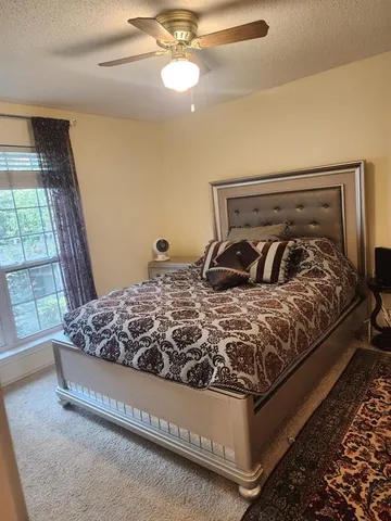 a bedroom with a bed and window