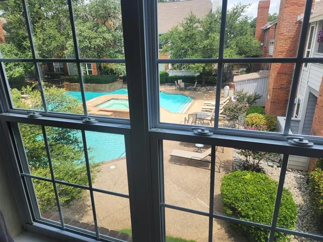 a swimming pool with outdoor seating and yard