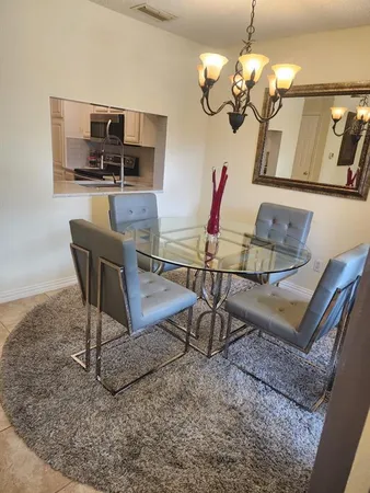 a view of a dining room with furniture wooden floor and chandelier