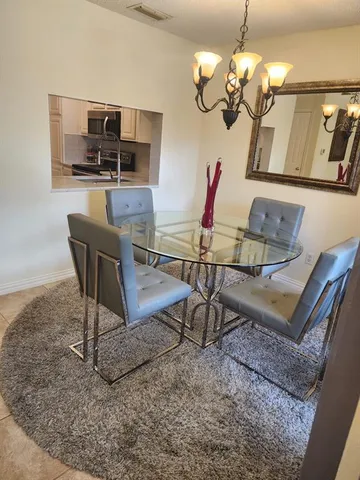 a view of a dining room with furniture wooden floor and chandelier