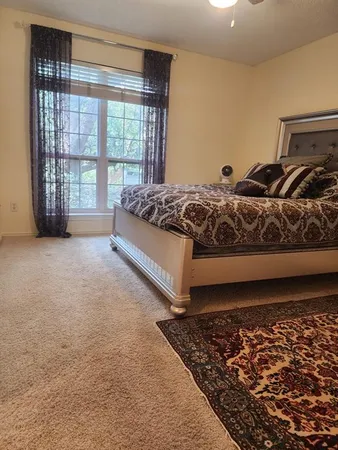 a spacious bedroom with a bed and a window