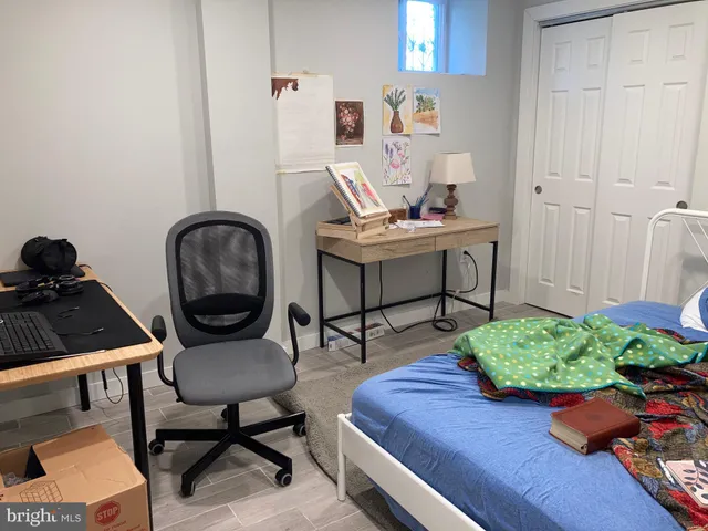 a work room with furniture and a potted plant