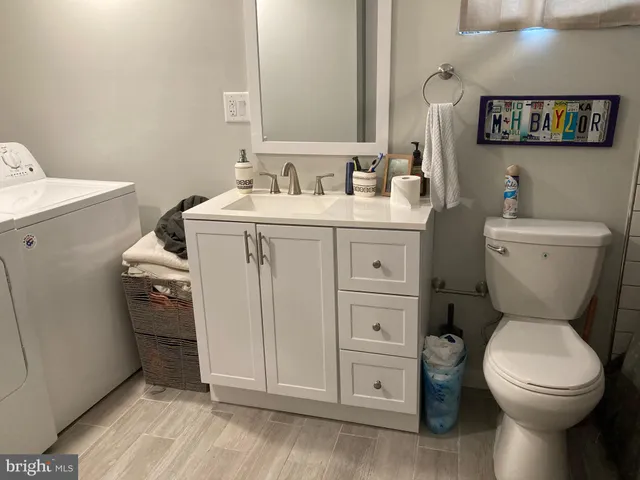 a bathroom with a toilet sink and mirror