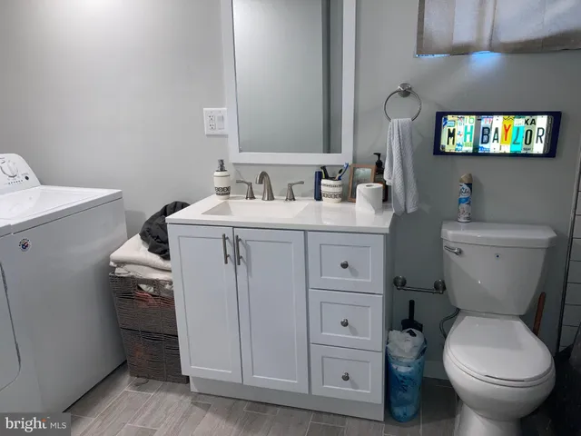 a bathroom with a toilet sink and mirror