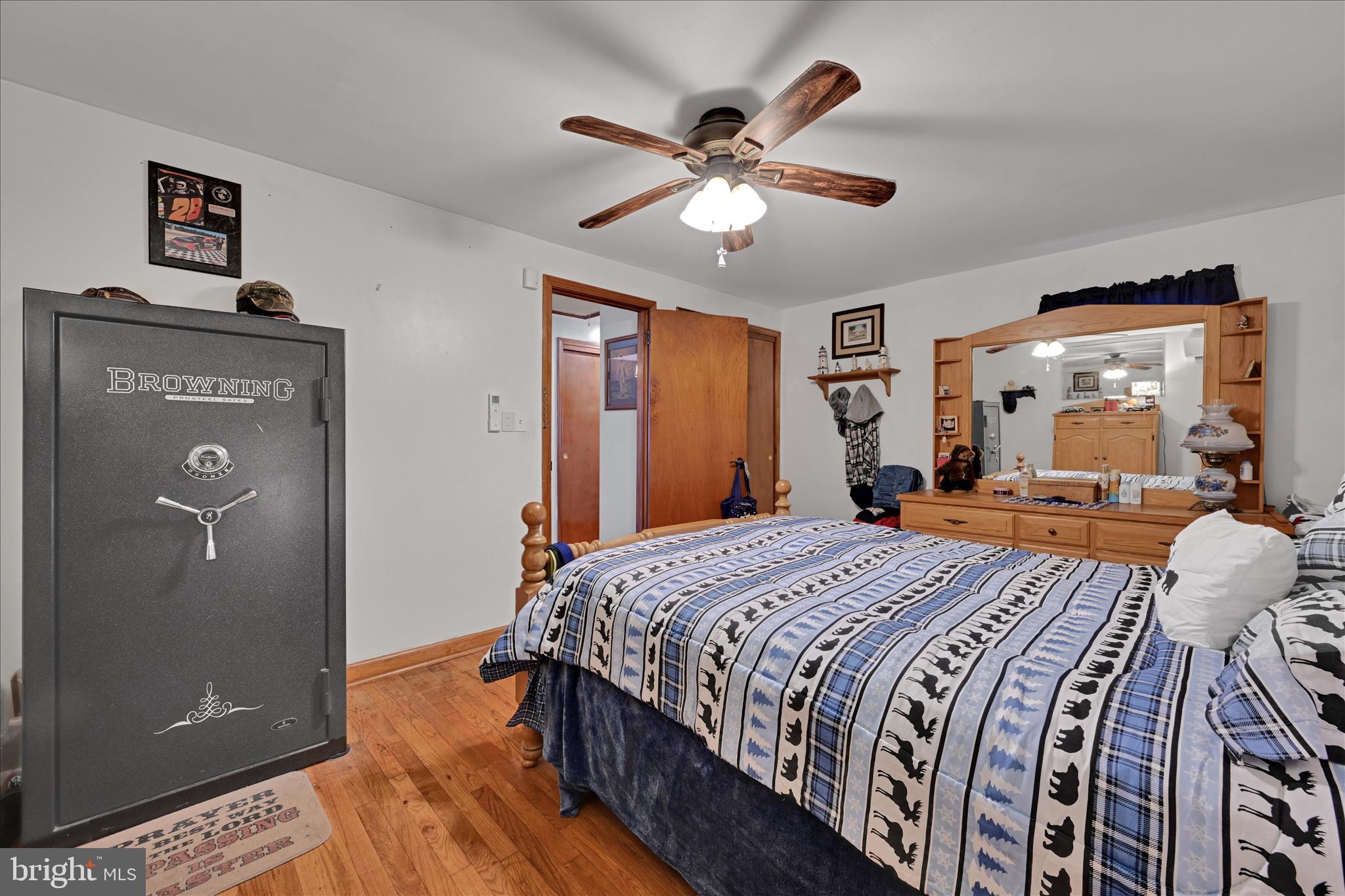 2440 Blue Ball Road Elkton, MD 21921 - Photo 19 of 30 a bedroom with a bed and a chandelier