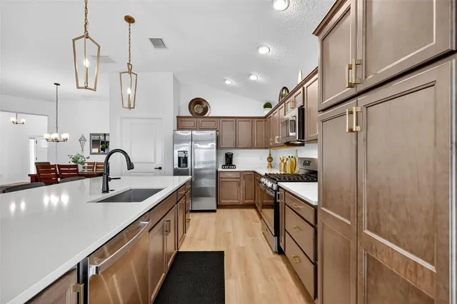a large kitchen with stainless steel appliances kitchen island a large island in the center