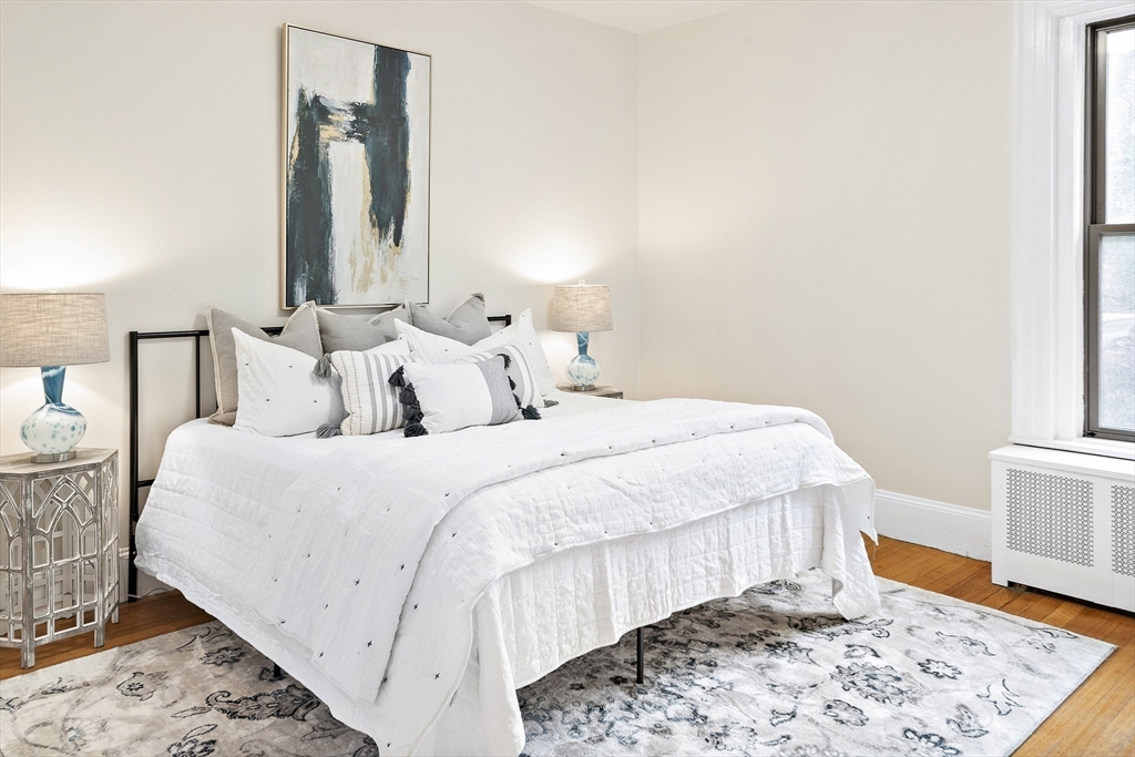 382 Commonwealth Avenue, Unit 24 Boston, MA 02215 - Photo 16 of 36 a bedroom with a bed and wooden floor