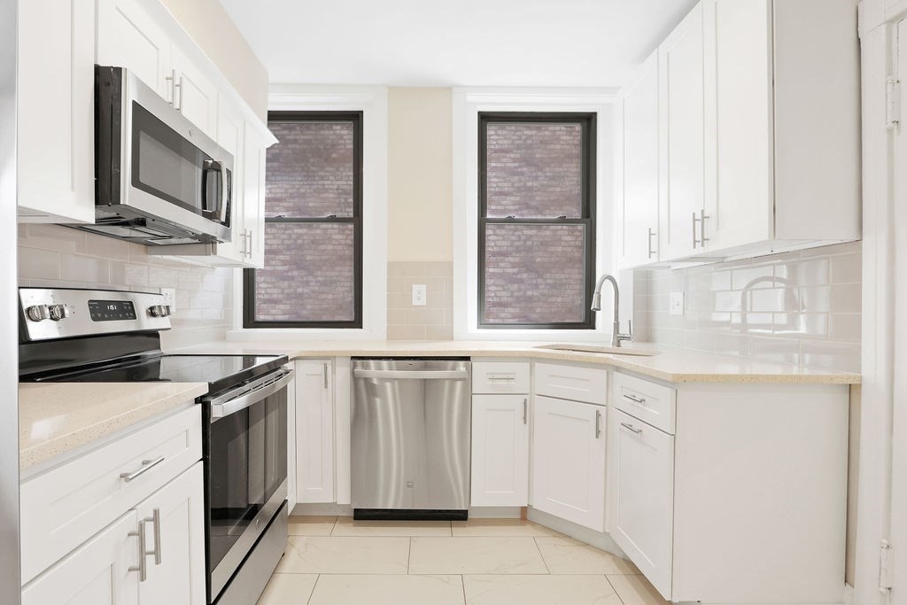 382 Commonwealth Avenue, Unit 24 Boston, MA 02215 - Photo 18 of 36 a kitchen with cabinets appliances and a window