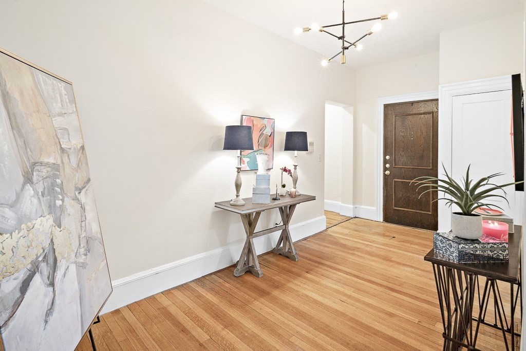 382 Commonwealth Avenue, Unit 24 Boston, MA 02215 - Photo 2 of 36 a bedroom with a bed and a chandelier