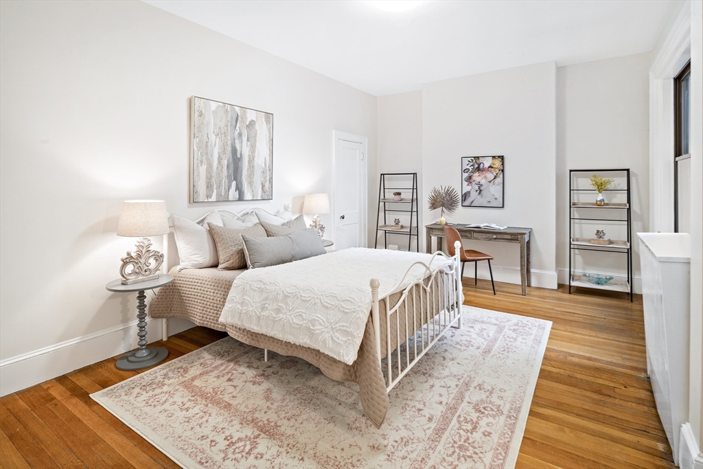 382 Commonwealth Avenue, Unit 24 Boston, MA 02215 - Photo 22 of 36 a bedroom with a bed wooden floor and lamp