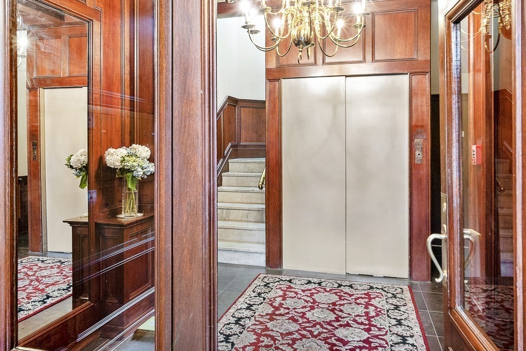 382 Commonwealth Avenue, Unit 24 Boston, MA 02215 - Photo 32 of 36 a view of hallway with a door and wooden floor