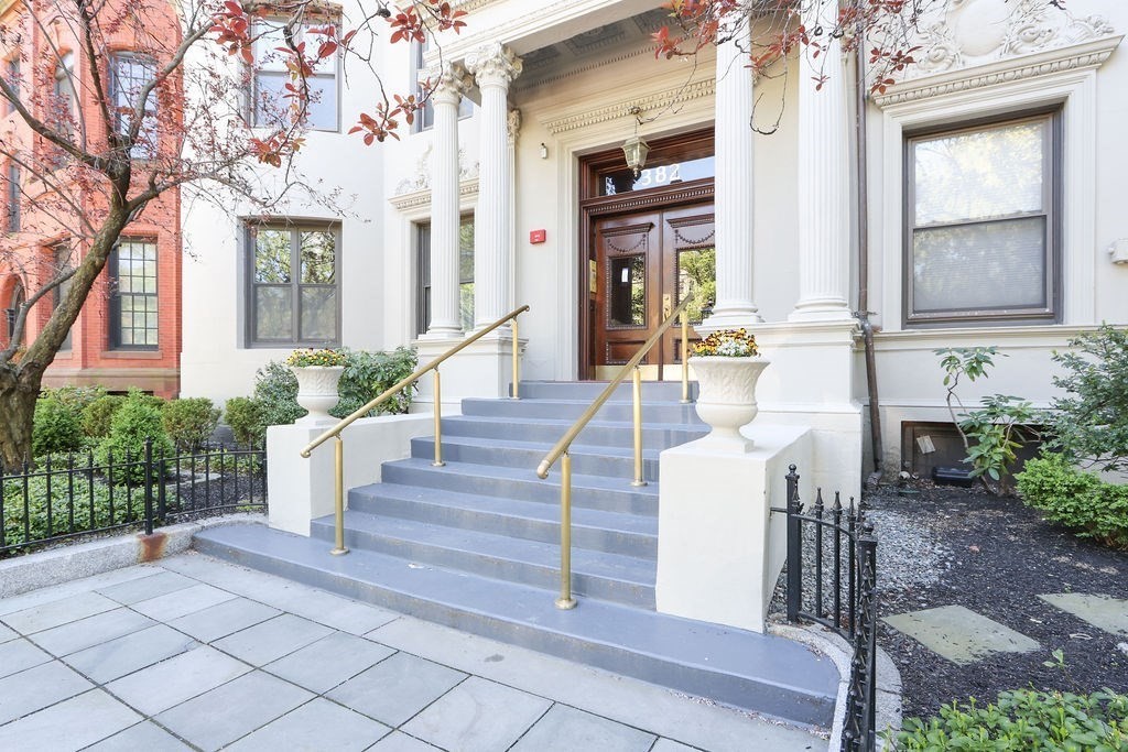 382 Commonwealth Avenue, Unit 24 Boston, MA 02215 - Photo 34 of 36 a front view of a house with wooden fence and a porch