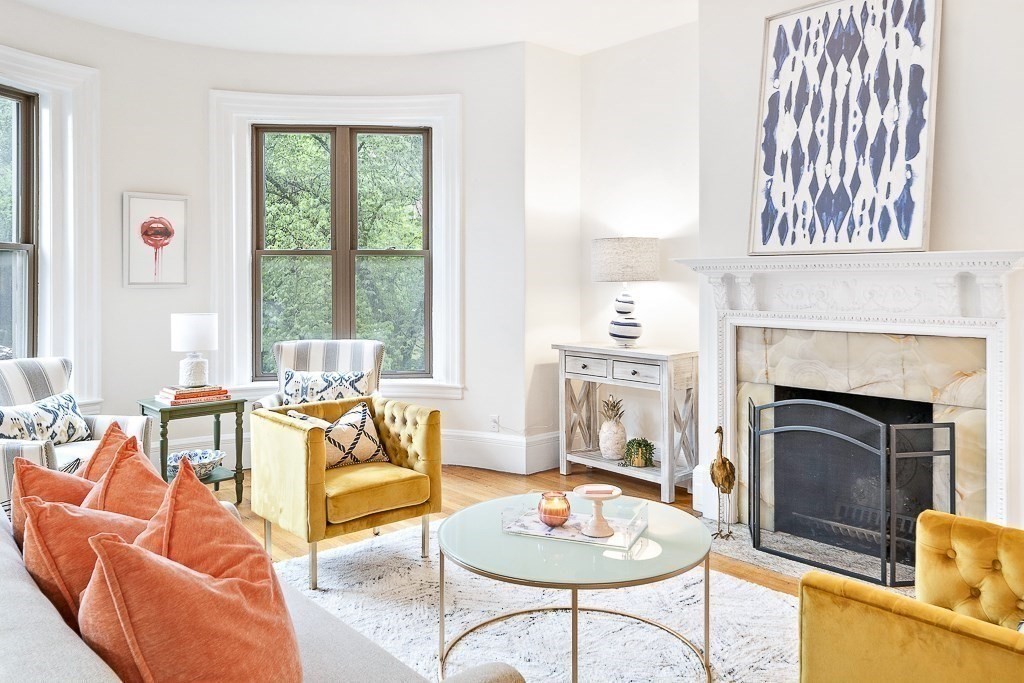 382 Commonwealth Avenue, Unit 24 Boston, MA 02215 - Photo 6 of 36 a living room with furniture a fireplace and a large window