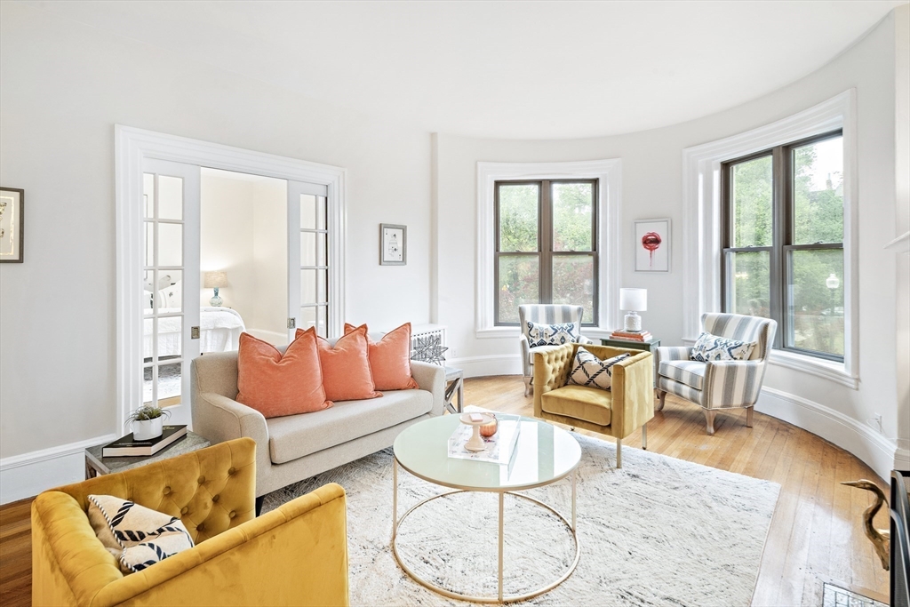 382 Commonwealth Avenue, Unit 24 Boston, MA 02215 - Photo 8 of 36 a living room with furniture and a large window