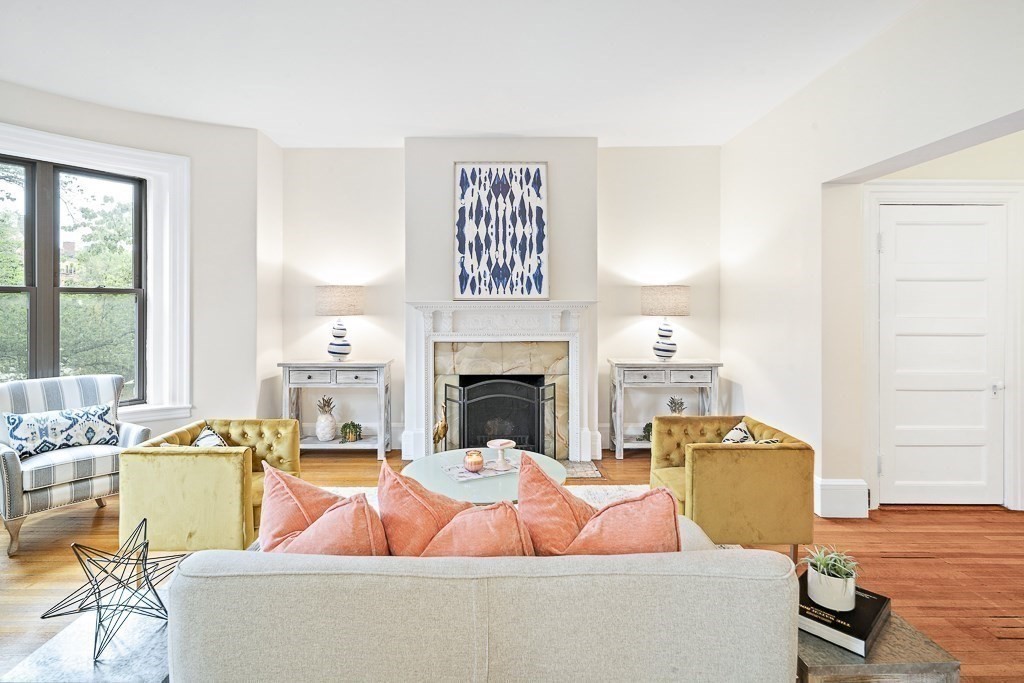 382 Commonwealth Avenue, Unit 24 Boston, MA 02215 - Photo 9 of 36 a living room with furniture a fireplace and a table