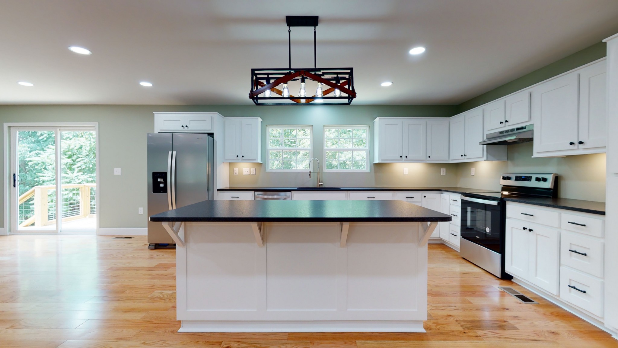 266 Lake Forrest Road Lynchburg, TN 37352 - Photo 16 of 40 a kitchen with kitchen island granite countertop wooden floor stainless steel appliances and cabinets