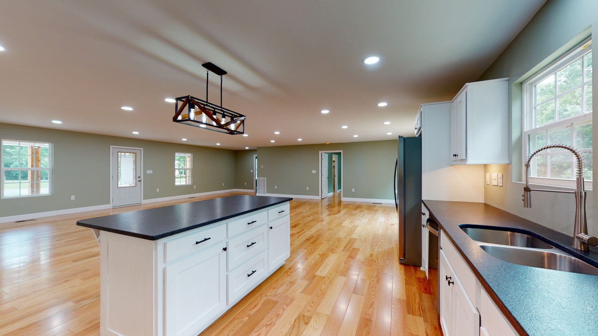 266 Lake Forrest Road Lynchburg, TN 37352 - Photo 20 of 40 a kitchen with stainless steel appliances granite countertop a sink a stove and a wooden floors