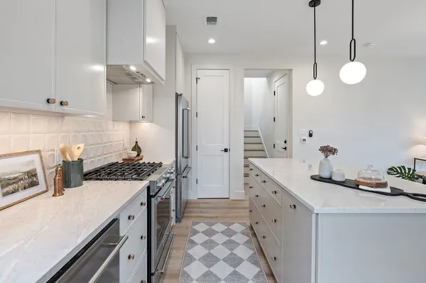 a kitchen with a sink stove and refrigerator