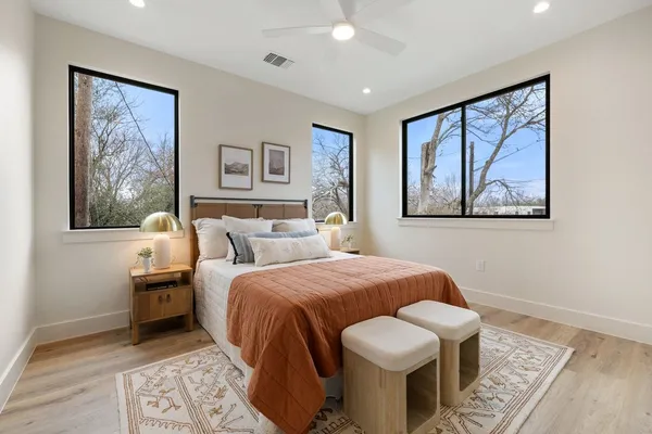 a bedroom with a bed and wooden floor