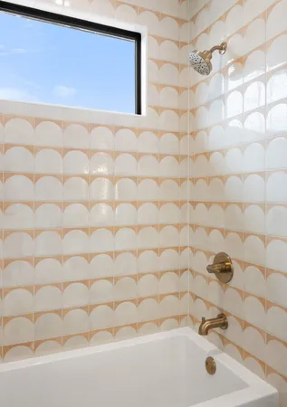 a bathroom with a white bathtub and a shower curtain