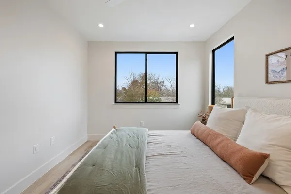 a bedroom with a bed and a painting on the wall