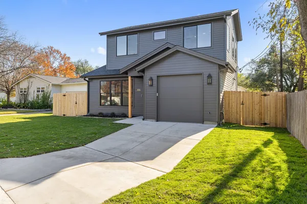 a front view of a house with garden