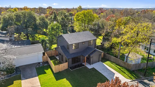 an aerial view of residential houses with outdoor space