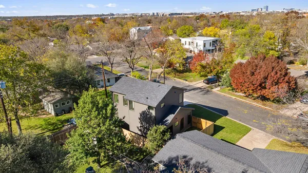 an aerial view of a house with swimming pool garden and patio