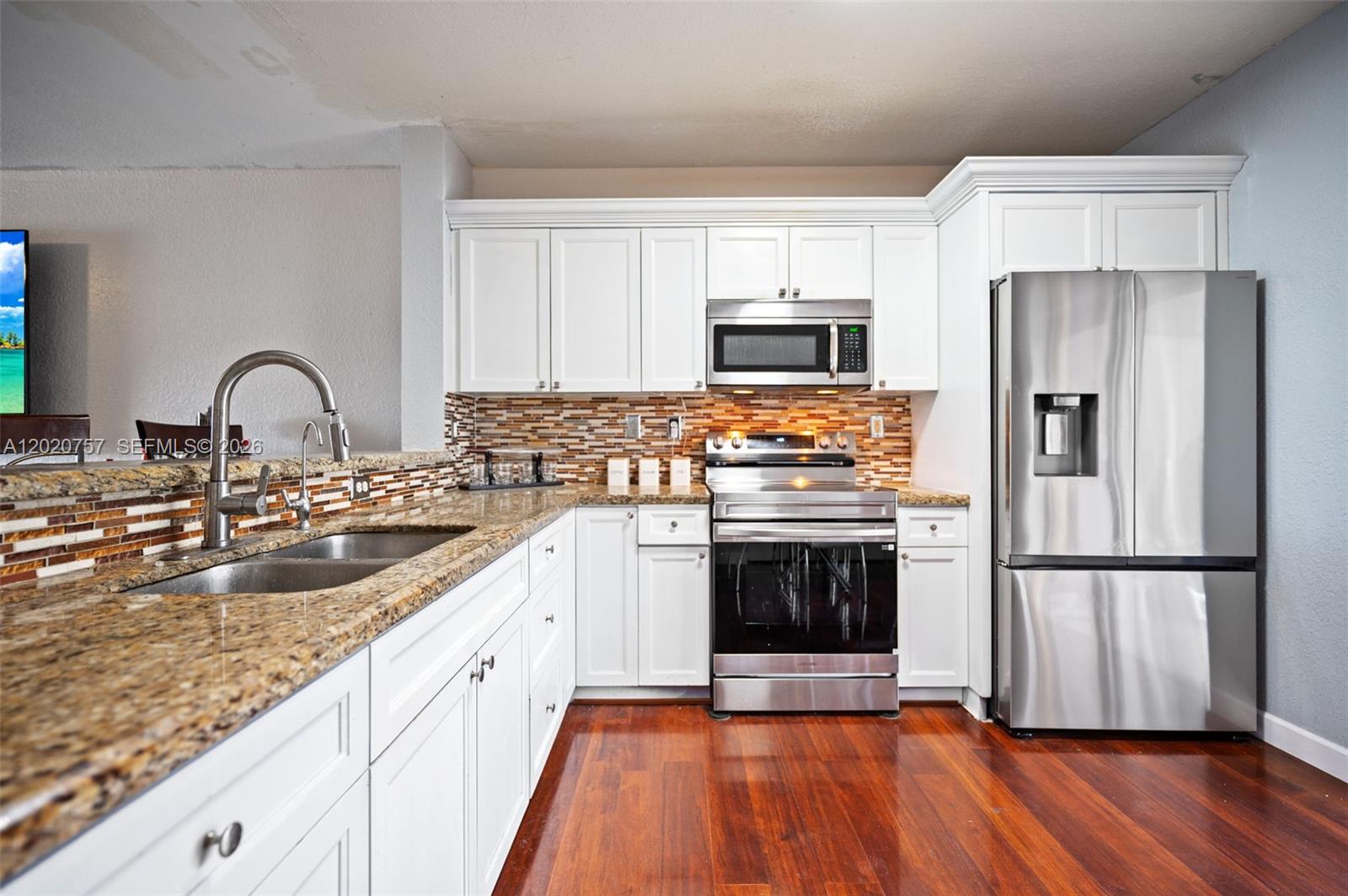 255 East 3rd Street, Unit 1 Hialeah, FL 33010 - Photo 5 of 38 a kitchen with stainless steel appliances granite countertop a refrigerator sink and stove